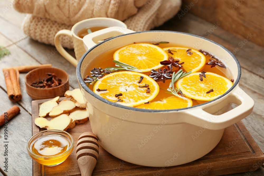 Saucepan with hot mulled wine on table