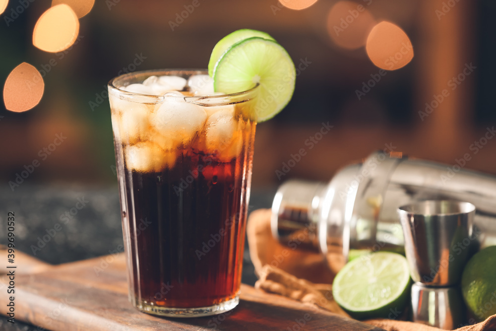 Glass of tasty Cuba Libre cocktail on table