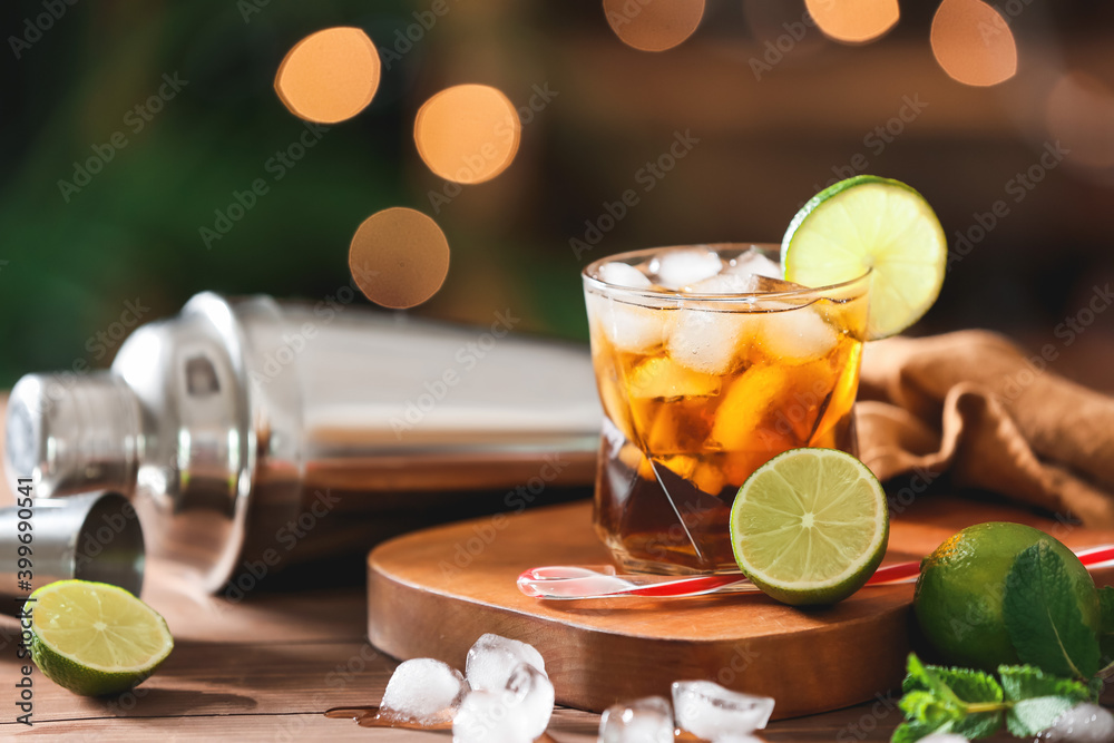 Glass of tasty Cuba Libre cocktail on table