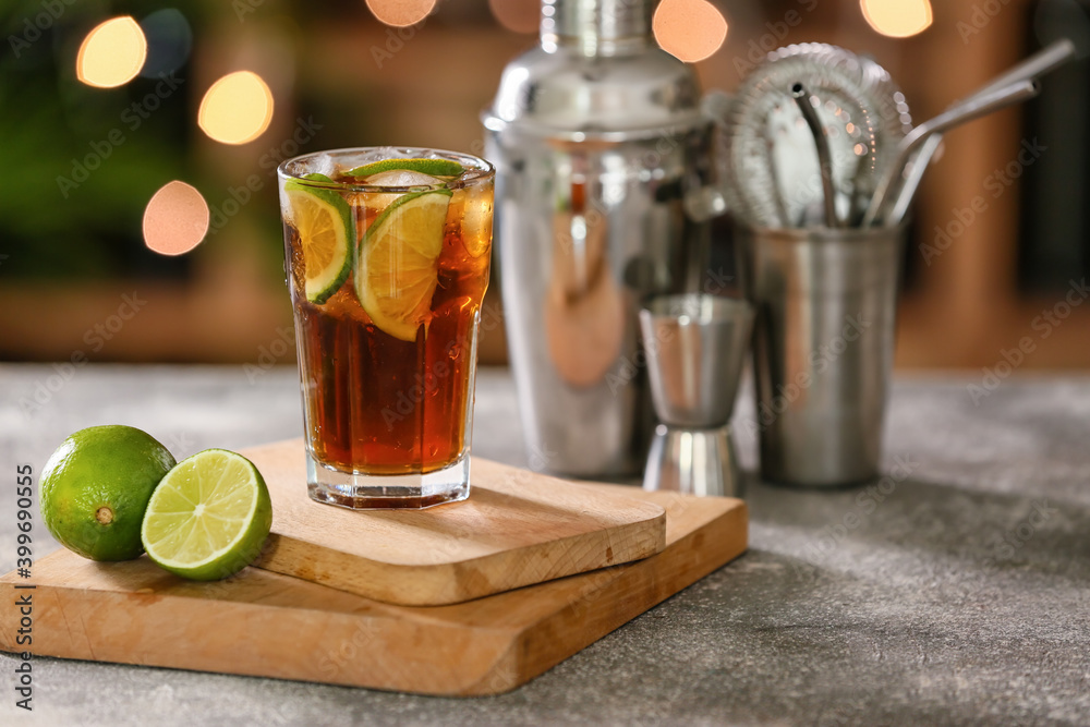 Glass of Cuba Libre cocktail on table