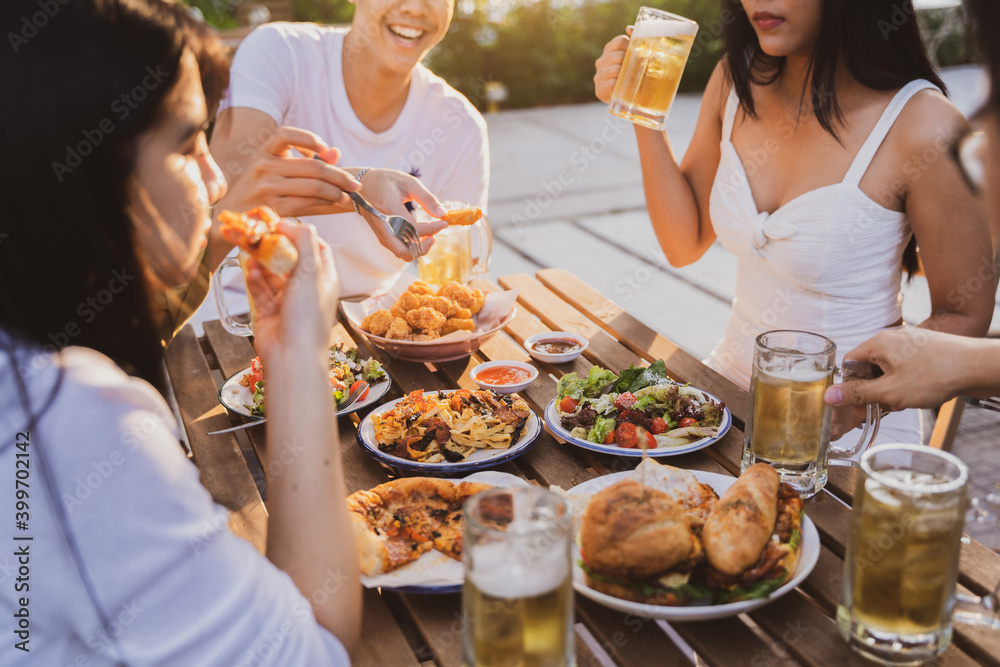 Group holiday party of asian people Eating dinner and drinking beer at home