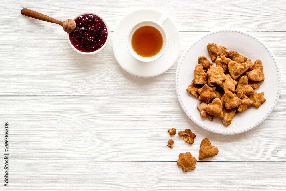 Tea with cookies and berry jam at home top view