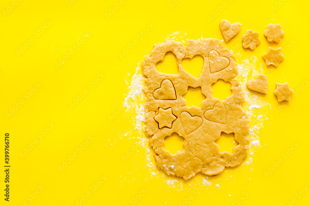 Heart shaped cookies cutting on dough, top view