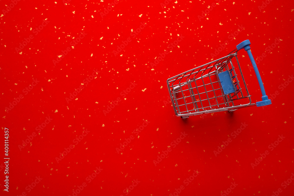 Shopping cart on golden red paper