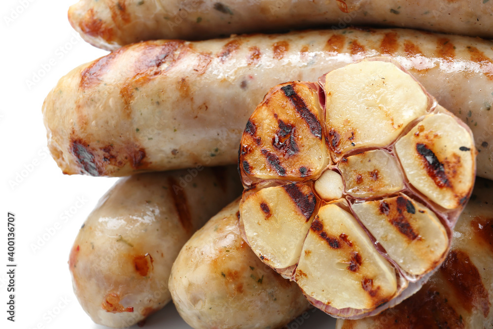 Delicious grilled sausages with garlic on white background