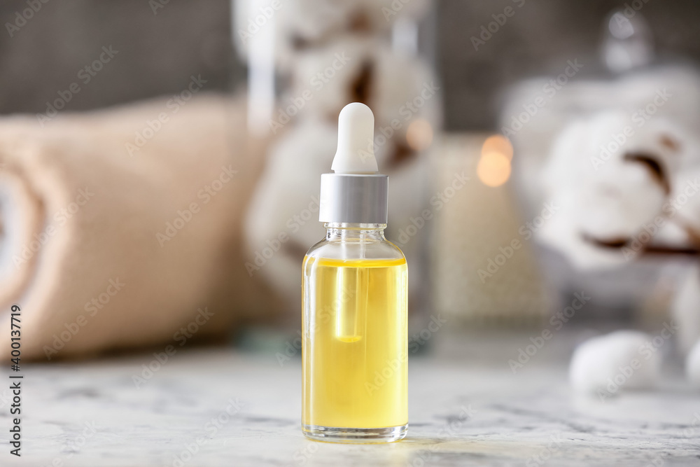 Bottle of essential cottonseed oil on table