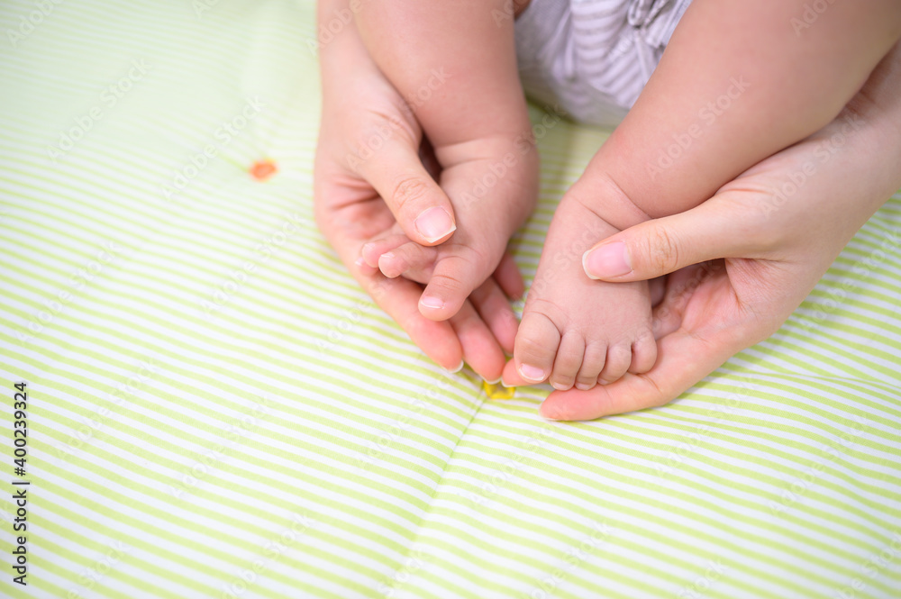 Baby feet in mother hand concept of love and Happiness of maternity