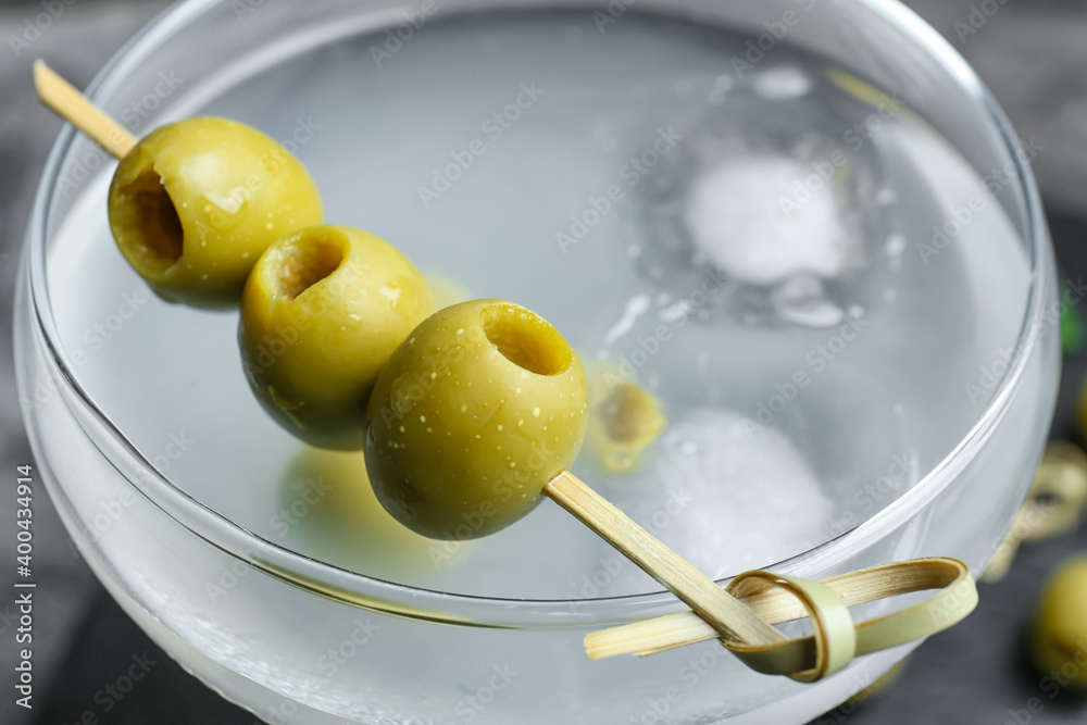 Glass of tasty martini with olives, closeup