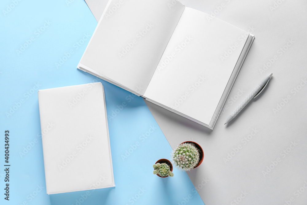 Blank books on color background