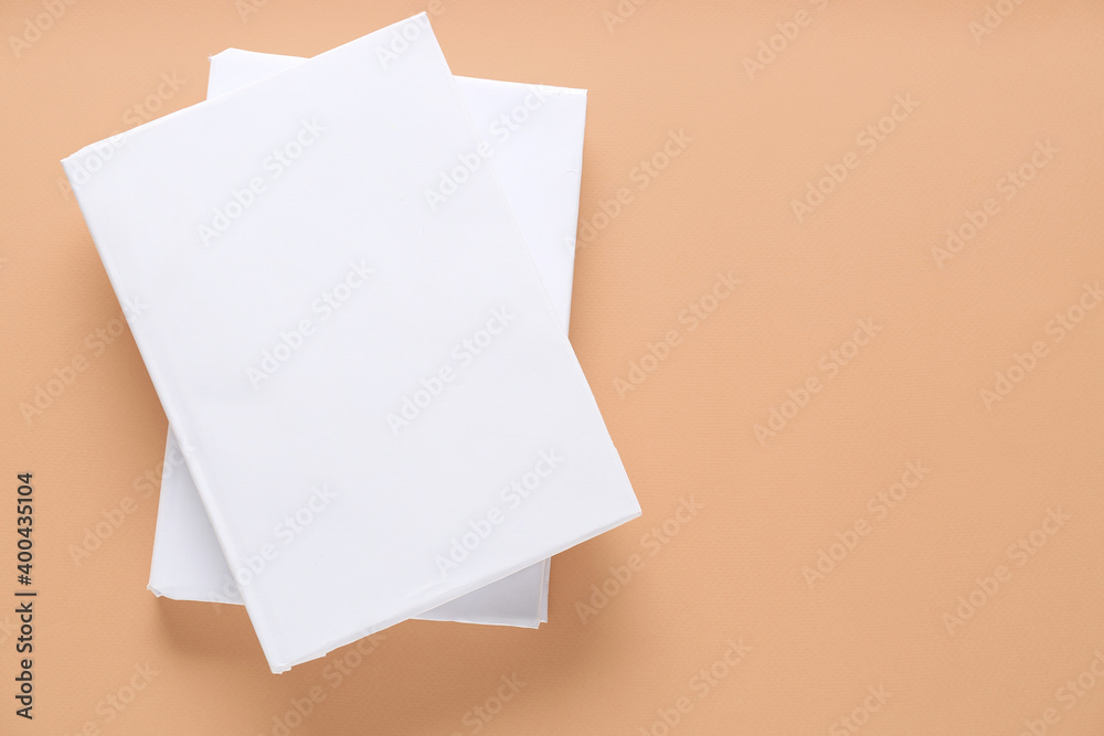 Blank books on color background