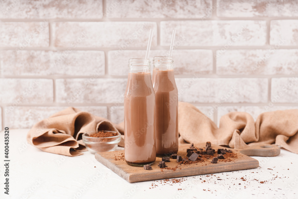 Bottles of aromatic chocolate milk on table