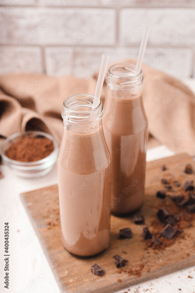 Bottles of aromatic chocolate milk on table