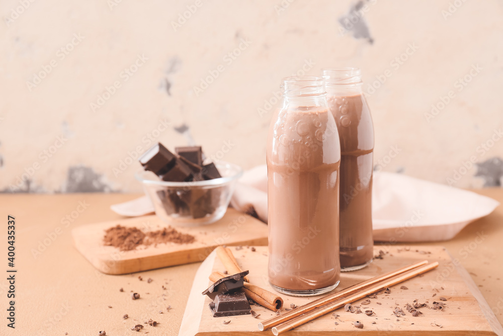 Bottles of aromatic chocolate milk on table