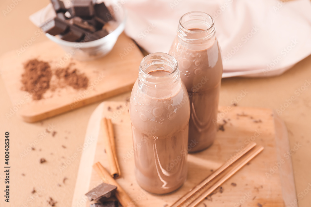 Bottles of aromatic chocolate milk on table