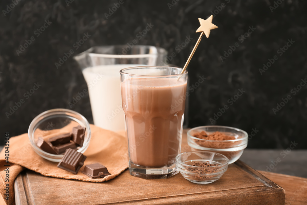 Glass of aromatic chocolate milk on dark background