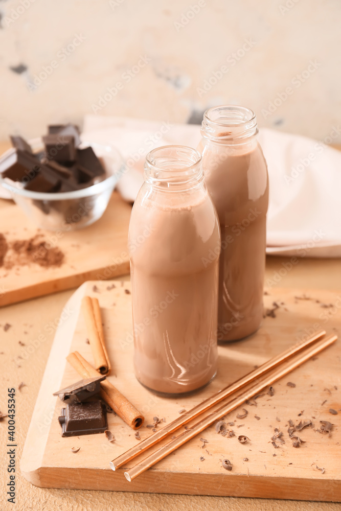 Bottles of aromatic chocolate milk on table