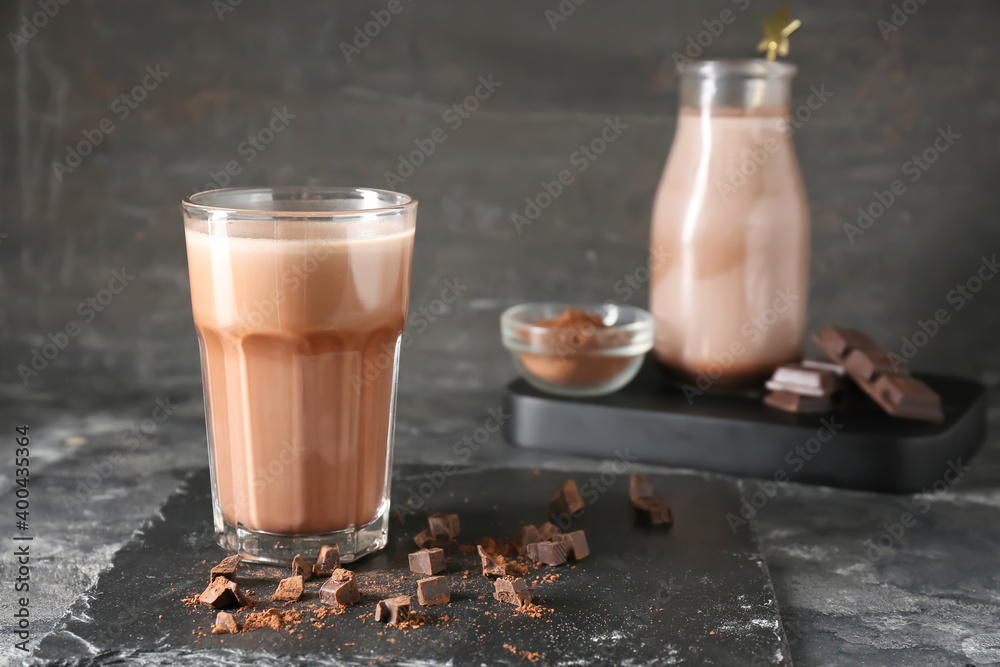 Glass of aromatic chocolate milk on dark background