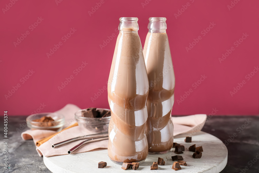 Bottles of tasty chocolate milk on table