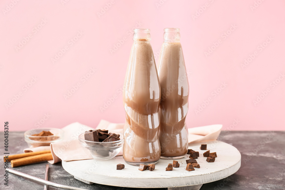 Bottles of tasty chocolate milk on table