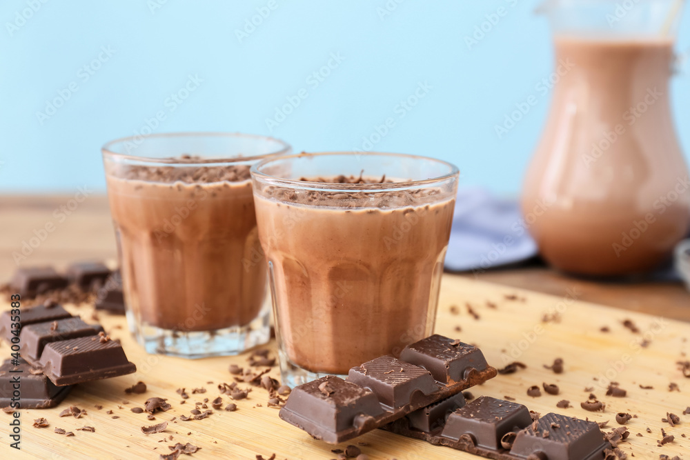 Glasses of tasty chocolate milk on table