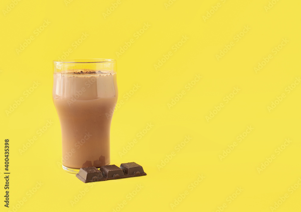 Glass of tasty chocolate milk on color background