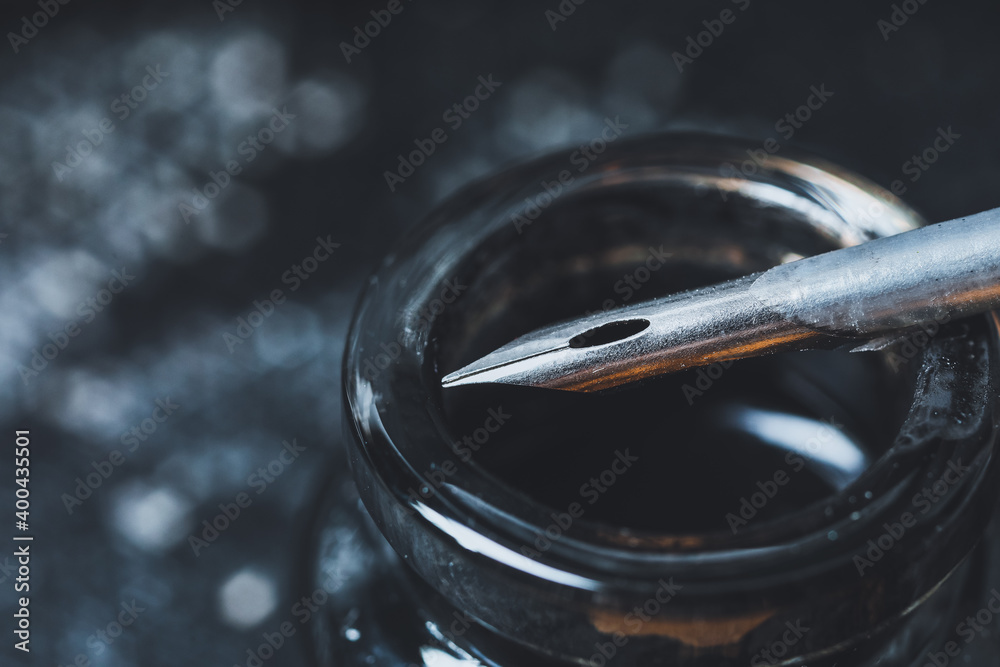 Feather pen and inkwell, closeup