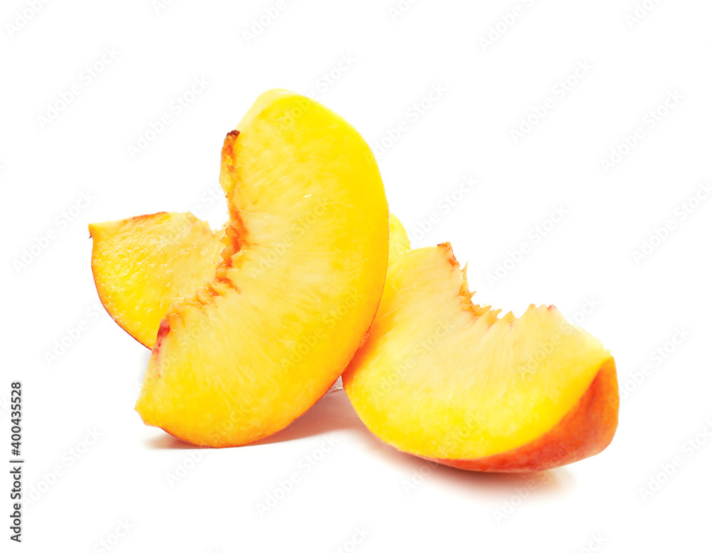 Pieces of ripe peach on white background