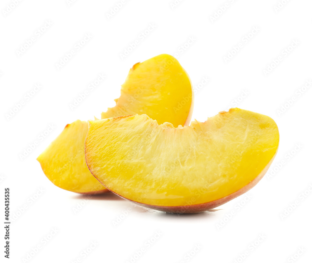 Pieces of ripe peach on white background