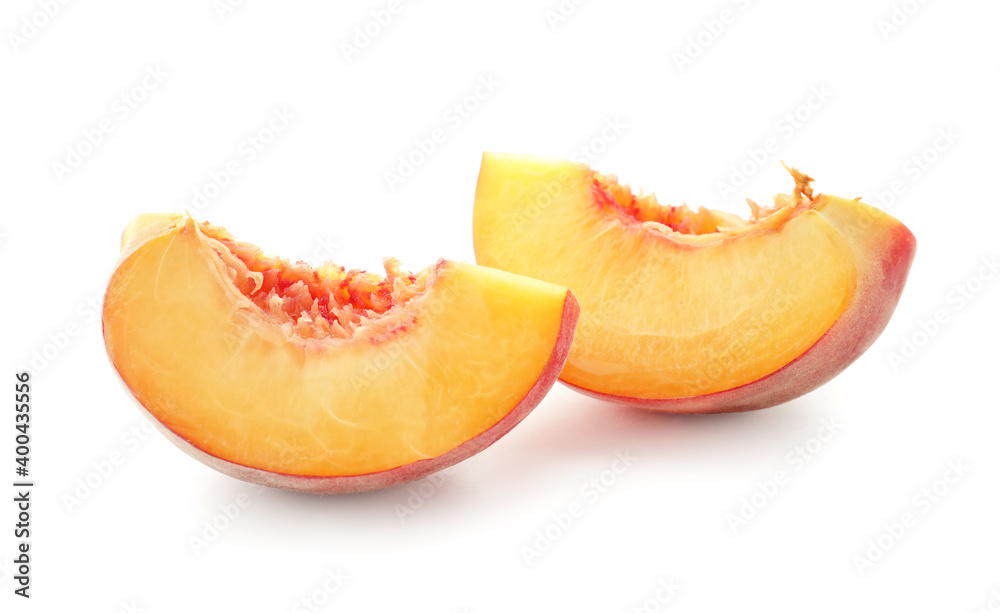 Pieces of ripe peach on white background