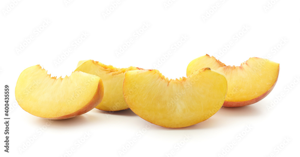 Pieces of ripe peach on white background