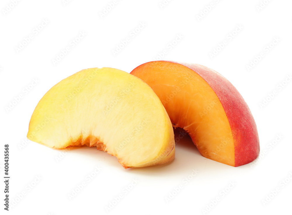 Pieces of ripe peach on white background