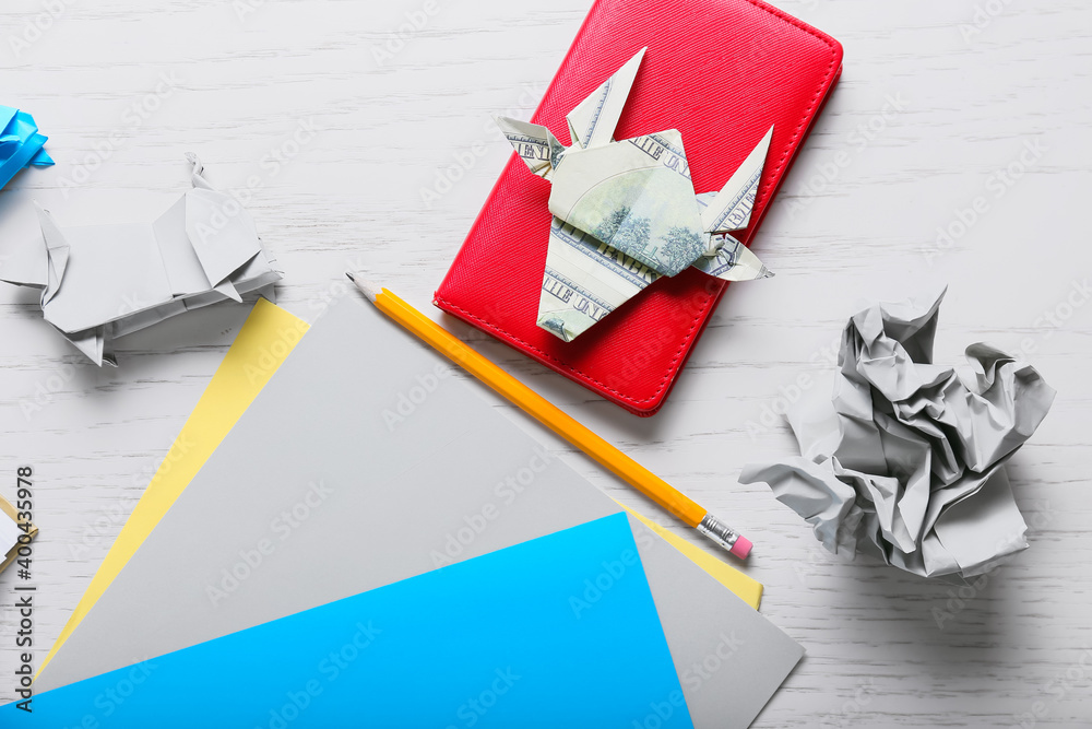 Stationery and origami bulls as symbol of year 2021 on table