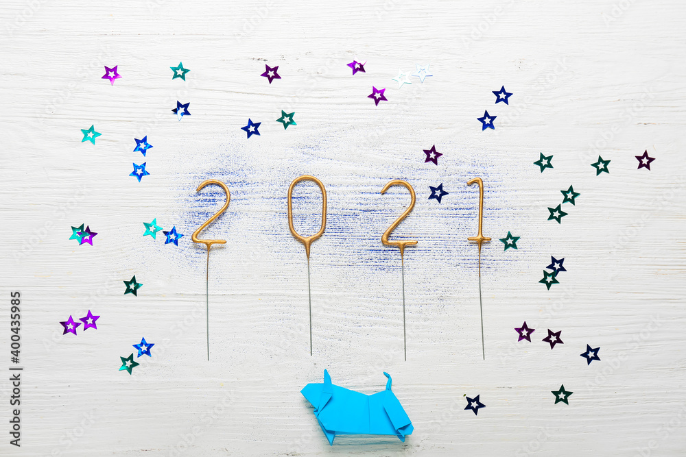 New Year composition with origami bull on white wooden background