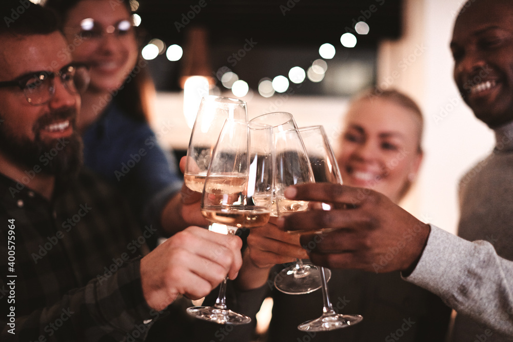 Smiling friends toasting each other during an dinner party