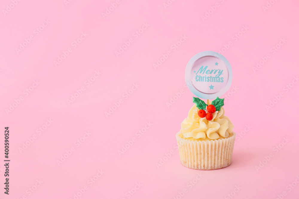 Tasty Christmas cupcake on color background