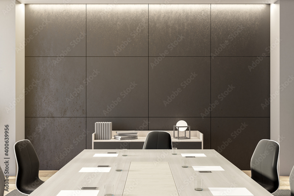 Comfortable meeting room with furniture and blank gray wall.