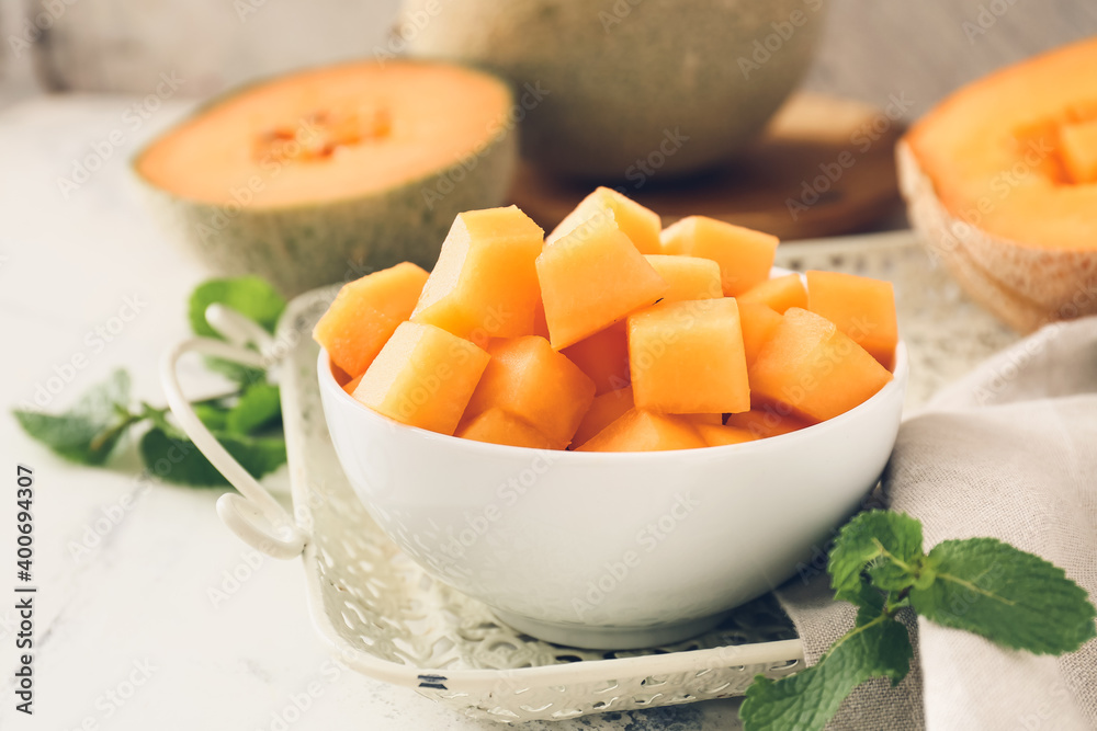 Bowl with sweet cut melon on table