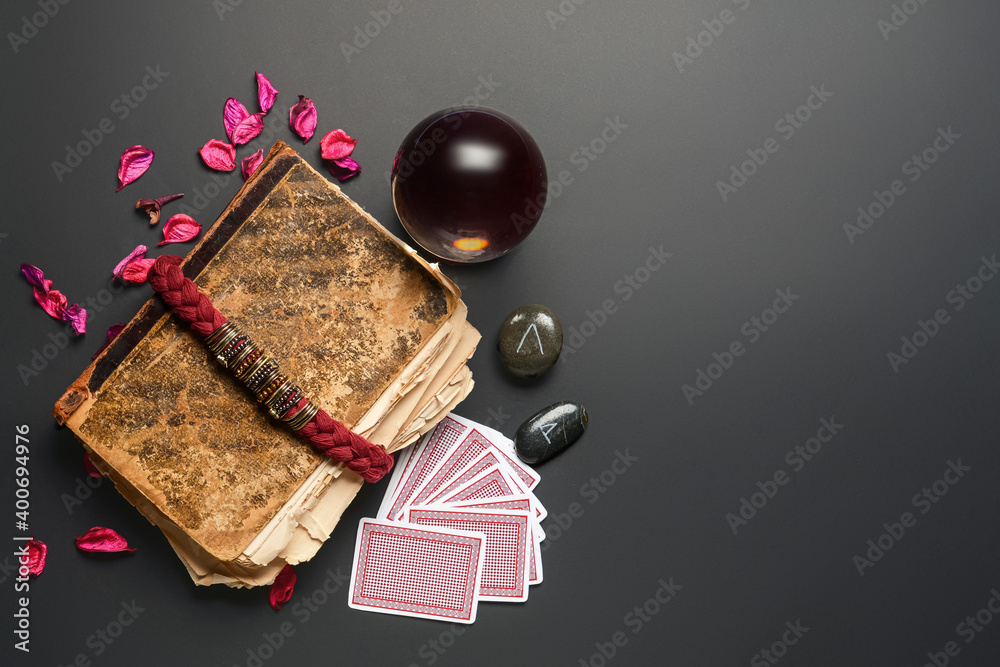 Accessories of fortune teller on dark background