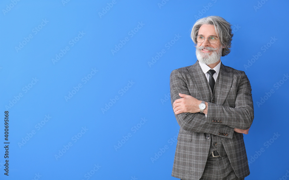 Portrait of senior businessman on color background