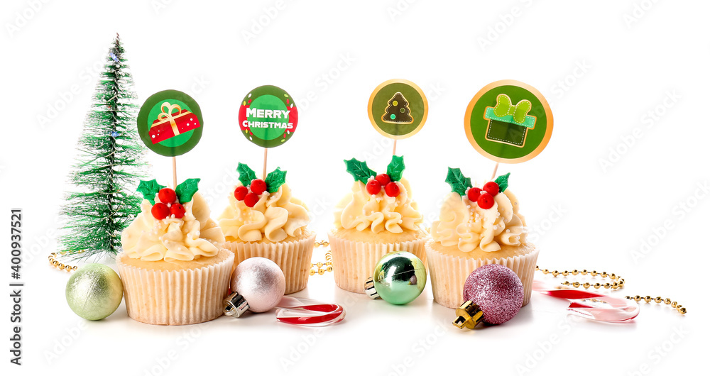 Tasty Christmas cupcakes and decor on white background