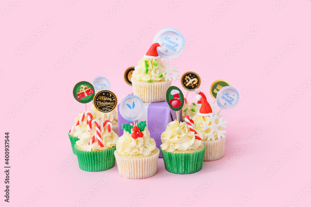 Composition with tasty Christmas cupcakes on color background