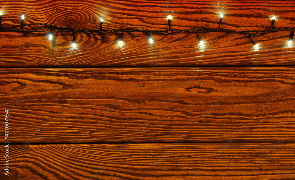 Сhristmas lights, background  ornaments on wood