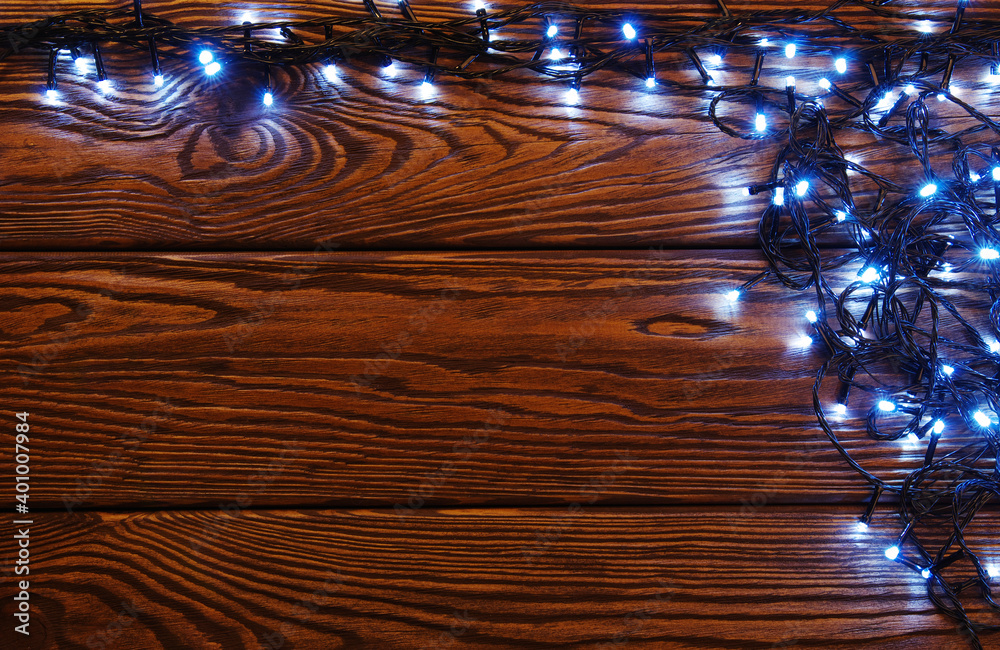 Сhristmas lights, background  ornaments on wood