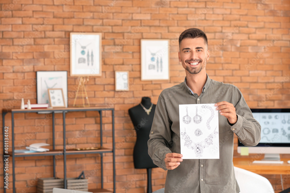 Male jewelry designer with sketches in office