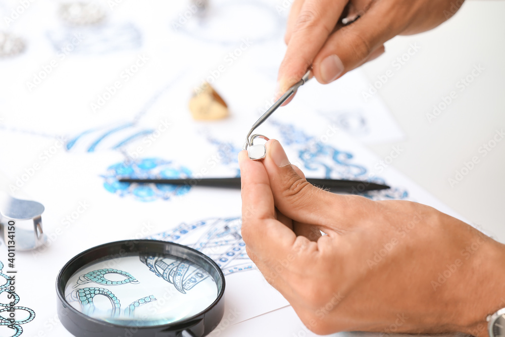 Male jewelry designer working in office, closeup