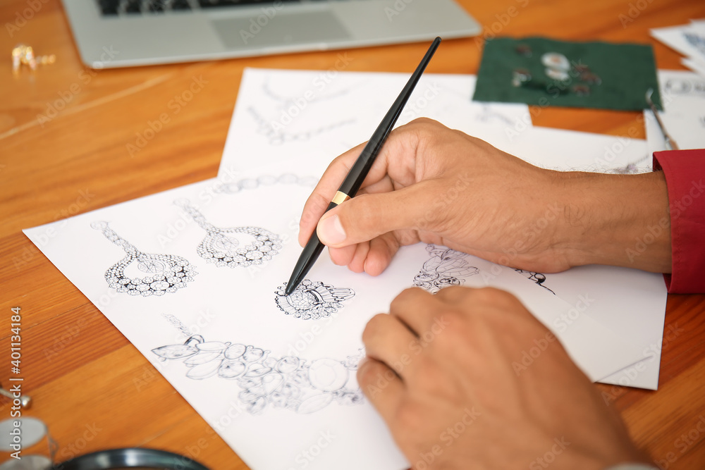 Male jewelry designer working in office