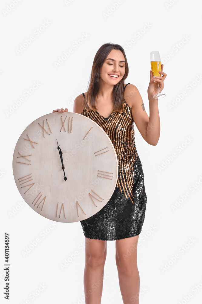 Beautiful young woman with clock and champagne on grey background. Christmas countdown concept