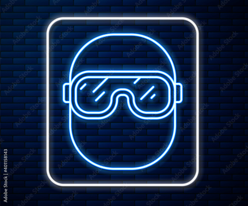 Glowing neon line Ski goggles icon isolated on brick wall background. Extreme sport. Sport equipment