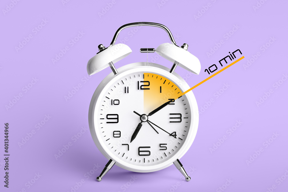 Alarm clock with timer for 10 minutes on color background. Time management concept