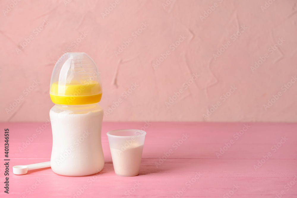 Bottle of baby milk formula on table